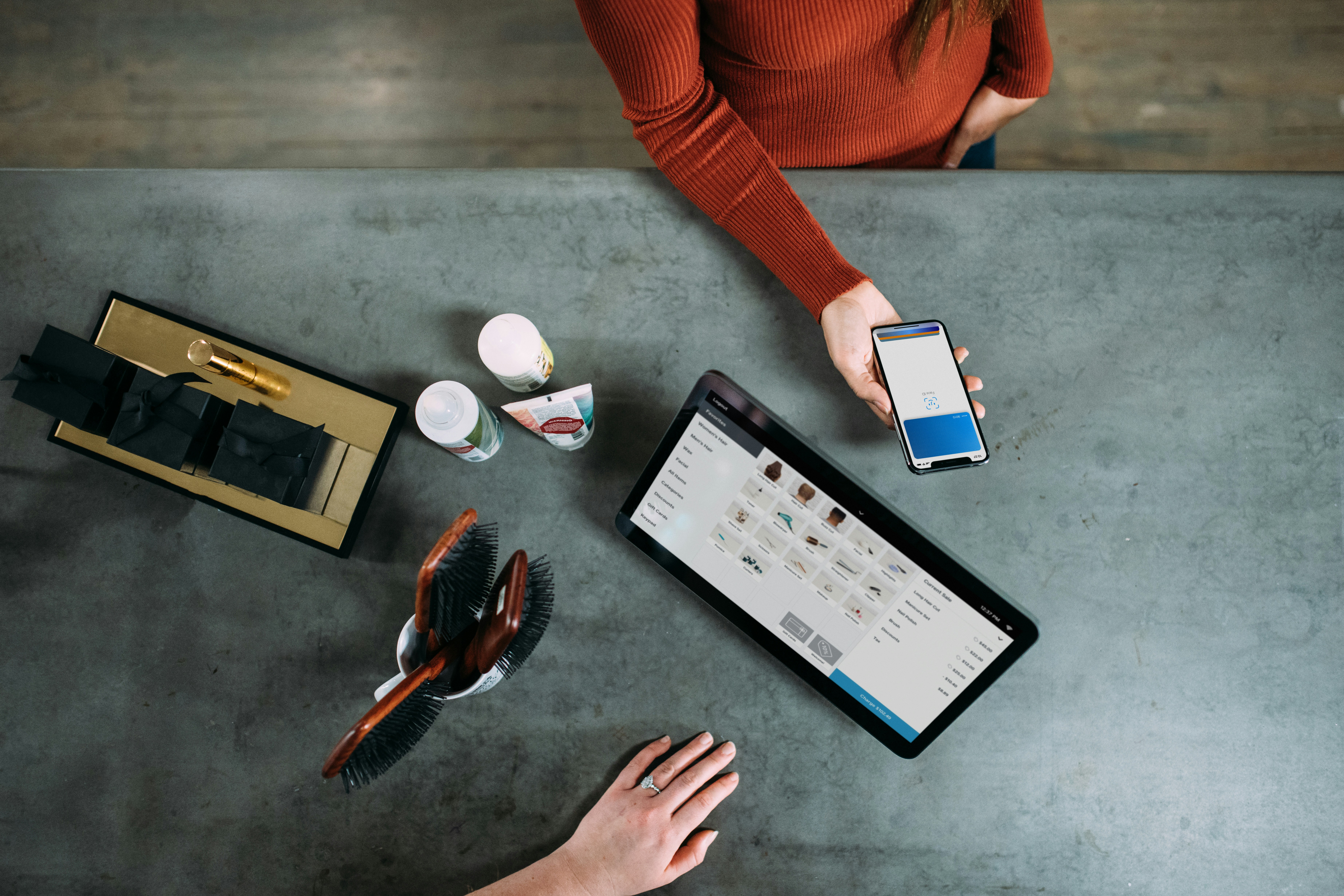 Persons using Mobile and Tablet while Standing beside a Table - Customer Journey Management